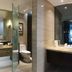 Great Wall Hotel (Yichang Cbd Food Street Store) bathroom with glass shower, vanity and toilet in Yichang