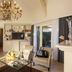 Les Manoirs de Tourgéville Deauville living room with chandelier, stairs, seating area and terrace view
