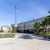 Super 8 by Wyndham Kenedy exterior with palm trees and clear blue sky in Kenedy