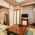Hotel Ikedaya, Matsumoto tatami room with low table, TV, and wall mirror
