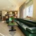 Hotel Maj Inn lobby lounge in Moravske Toplice with green leather seating and a bar