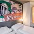 B&b Hotel Wiesbaden-Ost guest room with twin beds and Wiesbaden wall mural