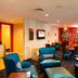 TownePlace Suites by Marriott Savannah Airport lobby seating area in Savannah with blue chairs and tables