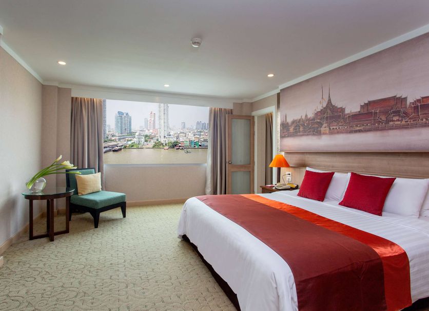 Ramada Plaza by Wyndham Bangkok Menam Riverside room with large city-view window and king bed in Bangkok