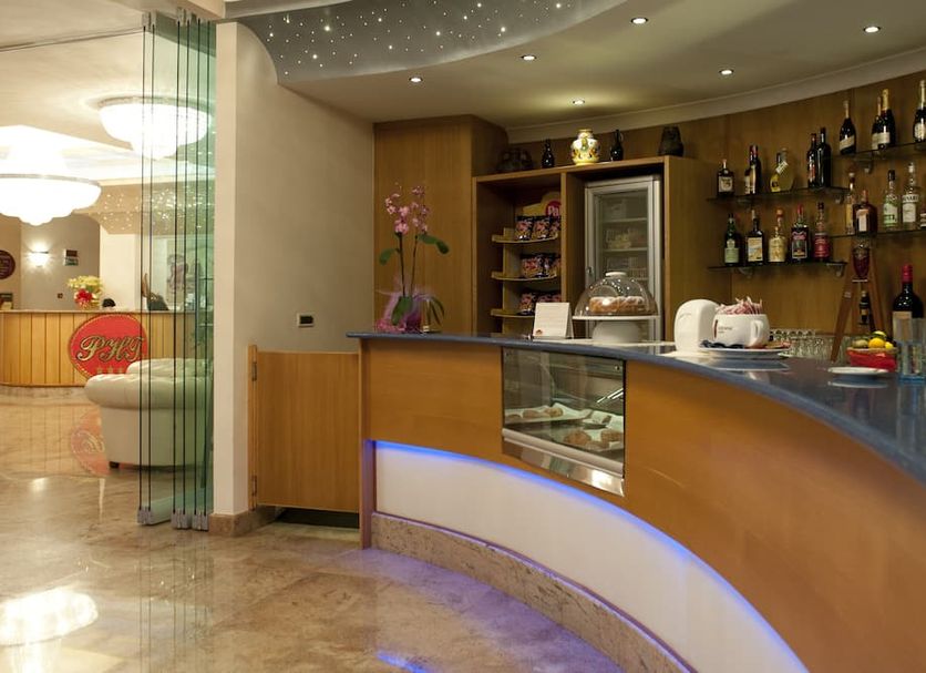 Park Hotel Tyrrenian in Amantea, hotel bar with curved counter, backlit display case and bottle shelves