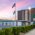 Wingate by Wyndham Sheboygan exterior with flags at sunset