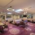 Thermenhotel Kurz in Lutzmannsburg lounge with dining tables, sofas, purple carpet and modern ceiling lights
