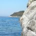 Hotel Rosa Del Tirreno in Quercianella with sea view framed by rocky cliffs and distant shoreline