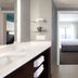 Residence Inn by Marriott Fishkill bathroom with vanity, walk-in shower and bedroom view
