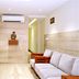 TR Residency Pondicherry lobby with sofa seating, wall art, and air conditioner in a bright hallway