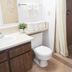 Bryce Uptop Lodge bathroom with vanity, toilet, towels, and shower curtain in Bryce