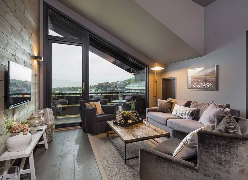 Highland Lodge in Geilo living room with large windows, sofa seating, and mountain views