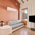 B&b Hotel Apartamentos Madrid Centro Fuencarral 46 room with sofa, TV, and windows in Madrid