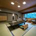 Nishimuraya Hotel Shogetsutei in Toyooka features a tatami room with low table and mountain-view windows