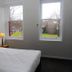 Crown Accommodation Bendigo Cbd bedroom with queen bed and two windows overlooking greenery