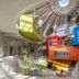 Hilton Garden Inn Tirana interior atrium with colorful suspended cube rooms and skylight