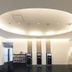 Hotel Shimbashi Sambankan lobby with circular ceiling light, self-service kiosks and reception in Tokyo