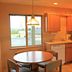 The Polynesian Resort in Ocean Shores kitchen with round dining table, wood cabinets and window view