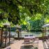 Waldhotel Silbermühle in Horn-Bad Meinberg: lakeside terrace with seating under leafy trees