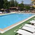 Nur Apart in Marmaris outdoor swimming pool with sun loungers and surrounding greenery