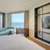 Grand Josun Busan room with ocean view, chaise lounge, desk, and floor-to-ceiling window in Busan