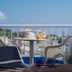 Belvedere Village in Agia Pelagia: rooftop terrace with chairs, table, and sea view