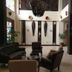 Rainbow Ruiru Resort Nairobi lobby with seating area, tall windows, potted plants and modern decor