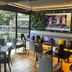 The Carrington Arms, Newport Pagnell: covered outdoor dining area with TV, tables and colorful cushions