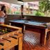Frangipani Hotel Boutique in Brotas game room with guests playing pool and foosball