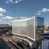 Loews Arlington Hotel in Arlington with a modern curved glass tower under a blue sky