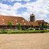 Premier Inn Milton Keynes South in Milton Keynes with a red-roofed building and windmill