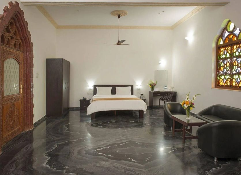 Le Pearl Goa Resort & Spa, Vagator: spacious room with bed, seating area, stained-glass window and marble floor