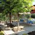 Hotel Baykal in Bogazkale outdoor garden seating area with tables, chairs, and red canopy