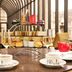 The Dilly London afternoon tea set on a table with sandwiches, scones and champagne glasses