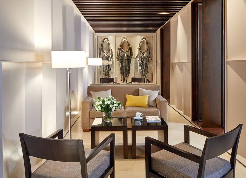 Hotel Posada Del Lucero Seville lounge with seating area, table, lamp and framed wall art