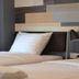 Campagne Hotel And Residence - Sha Plus guest room with twin beds and bedside lamp in Pathum Thani