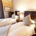 Old House Lodge in Beaufort West: twin beds with wooden headboards, bedside lamps and curtain-drawn window