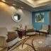 Wingfield Inn & Suites Owensboro lobby seating area with armchairs, sofa, and large windows
