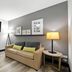 Country Inn & Suites by Radisson, Merrillville, IN room with sofa, TV and floor lamp