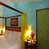 Sobrado da Vila Hotel in Mata de São João, a cozy four-poster bedroom with yellow curtains and bedside lamps