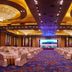 Fuhong International Hotel in Liaoyang ballroom with round tables, covered chairs and large stage screen