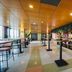 Leonardo Hotel Ijmuiden Seaport Beach lobby bar with high tables, plants, and tiled floors in IJmuiden