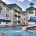 Lodge at Five Oaks Pigeon Forge pool with blue waterslide and lodge-style buildings in Sevierville