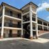 Motel 6 - Laurel, MS exterior with three-story motel building and outdoor stairway in Laurel