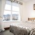 Trafalgar Lodge in Nelson bedroom with double bed and large window with mountain view
