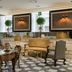 Relais & Châteaux Heritage Hotel Madrid lobby with ornate seating, patterned floor and wall art