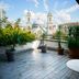 Terrace at Triada Hotel Taksim in Istanbul with potted plants and city views of a domed mosque