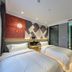 Mingcheng Hotel Beijing room with two single beds, modern wall art, and ensuite door in Beijing