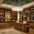 The Leo Kent Hotel, Tucson library-style lounge with chandelier, bookshelves and wooden desk