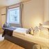 Arador City Hotel in Bad Oeynhausen guest room with single bed, desk, chair and window view